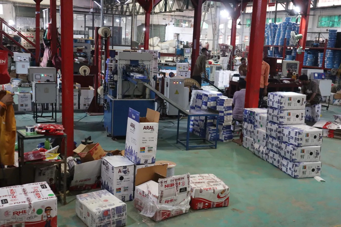 Workers packing Aral Gold and Rhein wire cartons on the packing floor