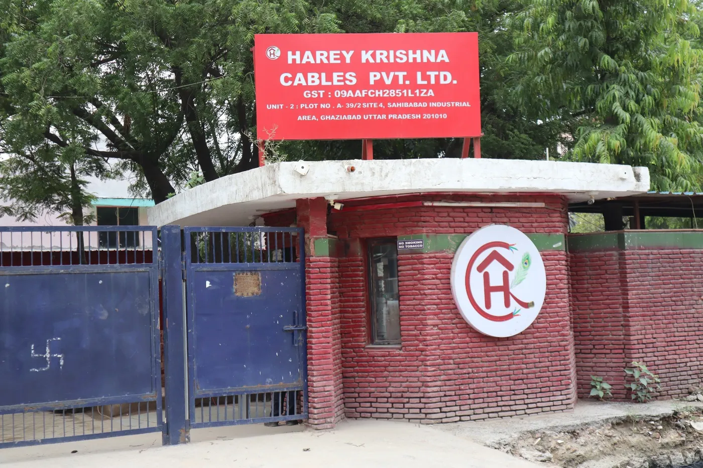 Close-up of the Harey Krishna Cables Pvt. Ltd. signboard at the Unit 2 entrance